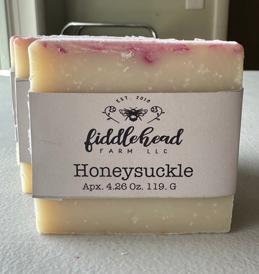 Bar of soap with 'fiddlehead farm LLC' label on a white surface